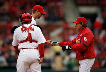 ST. LOUIS - APRIL 6:  Manager Tony La Russa takes the ball from pitcher Adam Wainwright #50 of the St. Louis Cardinals as catcher Yadier Molina looks on against the Pittsburgh Pirates during Opening Day on April 6, 2009 at Busch Stadium in St. Louis, Missouri.  The Pirates beat the Cardinals 6-4. (Photo by Dilip Vishwanat/Getty Images)  