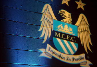 MANCHESTER, ENGLAND - MAY 24:  A Manchester City crest is projected onto the wall of the press conference room before the Barclays Premier League match between Manchester City and Bolton Wanderers at the City of Manchester Stadium on May 24, 2009 in Manchester, England.  (Photo by Richard Heathcote/Getty Images)