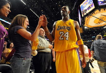 LOS ANGELES, CA - MAY 27:  Kobe Bryant #24 of the Los Angeles Lakers gives a fan a five after defeating the Denver Nuggets 103-94 in Game Five of the Western Conference Finals during the 2009 NBA Playoffs at Staples Center on May 27, 2009 in Los Angeles, California. NOTE TO USER: User expressly acknowledges and agrees that, by downloading and or using this photograph, User is consenting to the terms and conditions of the Getty Images License Agreement.  (Photo by Harry How/Getty Images)