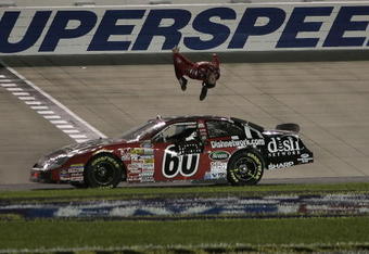NASHVILLE, TN - JUNE 09:  Carl Edwards, driver of the #60 Dish Network Ford, performs a backflip after winning the NASCAR Busch Series Federated Auto Parts 300 at the Nashville Superspeedway on June 9, 2007 in Nashville, Tennessee.  (Photo by Jason Smith/Getty Images for NASCAR)