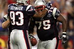 FOXBORO, MA - SEPTEMBER 8:  Defensive lineman Vince Wilfork #75 of the New England Patriots is congratulated by teammate Richard Seymour #93 after an interception against the Oakland Raiders during the 2005 NFL opening game at Gillette Stadium on September 8, 2005 in Foxboro, Massachusetts.  (Photo by Nick Laham/Getty Images)