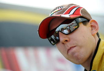 DOVER, DE - MAY 29:  Kyle Busch, driver of the #18 M&M's Toyota, stands in the garage area after qualifying for the NASCAR Sprint Cup Series Autism Speaks 400 at Dover International Speedway on May 29, 2009 in Dover, Delaware.  (Photo by Jeff Zelevansky/Getty Images for NASCAR)
