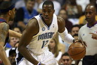ORLANDO, FL - MAY 30: Dwight Howard #12 of the Orlando Magic handles the ball against Mo Williams #2 of the Cleveland Cavaliers in Game Six of the Eastern Conference Finals during the 2009 Playoffs at Amway Arena on May 30, 2009 in Orlando, Florida. NOTE TO USER: User expressly acknowledges and agrees that, by downloading and or using this photograph, User is consenting to the terms and conditions of the Getty Images License Agreement  (Photo by Elsa/Getty Images)