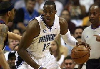 ORLANDO, FL - MAY 30: Dwight Howard #12 of the Orlando Magic handles the ball against Mo Williams #2 of the Cleveland Cavaliers in Game Six of the Eastern Conference Finals during the 2009 Playoffs at Amway Arena on May 30, 2009 in Orlando, Florida. NOTE TO USER: User expressly acknowledges and agrees that, by downloading and or using this photograph, User is consenting to the terms and conditions of the Getty Images License Agreement  (Photo by Elsa/Getty Images)