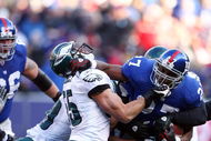 EAST RUTHERFORD, NJ - JANUARY 11:  Brandon Jacobs #27 of the New York Giants runs against Stewart Bradley #55 of the Philadelphia Eagles during the NFC Divisional Playoff Game on January 11, 2009 at Giants Stadium in East Rutherford, New Jersey.  (Photo by Al Bello/Getty Images)