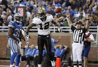 DETROIT - DECEMBER 21: Wide receiver Marques Colston #12 of the New Orleans Saints scores on a six yard pass in the third quarter against the Detroit Lions on December 21, 2008 at Ford Field in Detroit, Michigan. The New Orleans Saints defeated the Detroit Lions 42-7.  (Photo by Leon Halip/Getty Images)