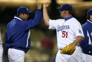 LOS ANGELES, CA - JUNE 03:  Closer Jonathan Broxton #51 and pitcher Hiroki Kuroda #18 of the Los Angeles Dodgers celebrate after the game against the Arizona Diamondbacks on June 3, 2009 at Dodger Stadium in Los Angeles, California.  Broxton pickup up his 13th save as the Dodgers won 1-0.  (Photo by Stephen Dunn/Getty Images)