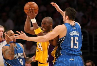 LOS ANGELES - JANUARY 16:  Kobe Bryant #24 of the Los Angeles Lakers looks to make a play to the basket against Jameer Nelson #14 and Hedo Turkoglu #15 of the Orlando Magic during their NBA game on January 16, 2009 at Staples Center in Los Angeles, California. The Magic won 109-103.   NOTE TO USER: User expressly acknowledges and agrees that, by downloading and/or using this Photograph, user is consenting to the terms and conditions of the Getty Images License Agreement. (Photo by Stephen Dunn/Getty Images)