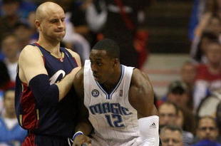 ORLANDO, FL - MAY 30: Dwight Howard #12 of the Orlando Magic handles the ball against Zydrunas Ilgauskas #11 of the Cleveland Cavaliers in Game Six of the Eastern Conference Finals during the 2009 Playoffs at Amway Arena on May 30, 2009 in Orlando, Florida. NOTE TO USER: User expressly acknowledges and agrees that, by downloading and or using this photograph, User is consenting to the terms and conditions of the Getty Images License Agreement  (Photo by Elsa/Getty Images)
