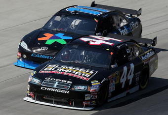 DOVER, DE - MAY 31:  AJ Allmendinger, driver of the #44 Auto Value Bumper Dodge leads Denny Hamlin, driver of the #11 FedEx Office Toyota during the NASCAR Sprint Cup Series Autism Speaks 400 at Dover International Speedway on May 31, 2009 in Dover, Delaware.  (Photo by Nick Laham/Getty Images)