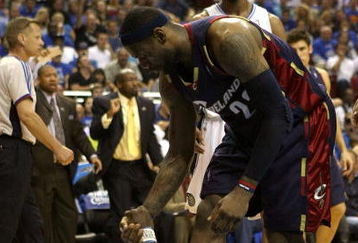 ORLANDO, FL - MAY 30:  LeBron James #23 of the Cleveland Cavaliers helps Mickael Pietrus #20 of the Orlando Magic up off the court in Game Six of the Eastern Conference Finals during the 2009 Playoffs at Amway Arena on May 30, 2009 in Orlando, Florida. NOTE TO USER: User expressly acknowledges and agrees that, by downloading and or using this photograph, User is consenting to the terms and conditions of the Getty Images License Agreement  (Photo by Elsa/Getty Images)