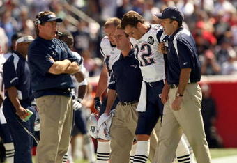 FOXBORO, MA - SEPTEMBER 7:  Quarterback Tom Brady #12 of the New England Patriots walks off the field with the aid of the Patriots staff after being injured on a play during their NFL game against the Kansas City Chiefs on September 7, 2008 at Gillette Stadium in Foxboro, Massachusetts. The Patriots defeated the Chiefs 17-10. (Photo by Elsa Garrison/Getty Images)