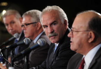 CHICAGO - OCTOBER 16:  Joel Quenneville (2nd-R) is introduced as the new head coach of the Chicago Blackhawks at a press conference on October 16, 2008 at the United Center in Chicago, Illinois. John McDonough, Blackhawks President (L), Dale Tallon (2nd-L), Blackhawks General Manager, and Scotty Bowman, Blackhawks Senior Advisor, Hockey Operations (R) attend. (Photo by David Banks/Getty Images)