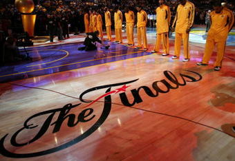 LOS ANGELES, CA - JUNE 04:  The Los Angeles Lakers stand during the national anthem before taking on the Orlando Magic in Game One of the 2009 NBA Finals at Staples Center on June 4, 2009 in Los Angeles, California. NOTE TO USER: User expressly acknowledges and agrees that, by downloading and or using this photograph, User is consenting to the terms and conditions of the Getty Images License Agreement.  (Photo by Jed Jacobsohn/Getty Images)