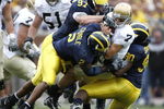 ANN ARBOR, MI - SEPTEMBER 15: Jimmy Clausen #7 of the Notre Dame Fighting Irish is sacked by Shawn Crable #2, Tim Jamison #90 and Will Johnson #97 of the  Michigan Wolverines at Michigan Stadium September 15, 2007 in Ann Arbor, Michigan. (Photo By Gregory Shamus/Getty Images)