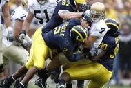 ANN ARBOR, MI - SEPTEMBER 15: Jimmy Clausen #7 of the Notre Dame Fighting Irish is sacked by Shawn Crable #2, Tim Jamison #90 and Will Johnson #97 of the Michigan Wolverines at Michigan Stadium September 15, 2007 in Ann Arbor, Michigan. (Photo By Gregory Shamus/Getty Images)