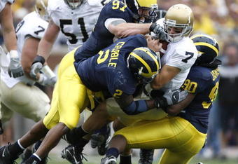 ANN ARBOR, MI - SEPTEMBER 15: Jimmy Clausen #7 of the Notre Dame Fighting Irish is sacked by Shawn Crable #2, Tim Jamison #90 and Will Johnson #97 of the  Michigan Wolverines at Michigan Stadium September 15, 2007 in Ann Arbor, Michigan. (Photo By Gregory Shamus/Getty Images)