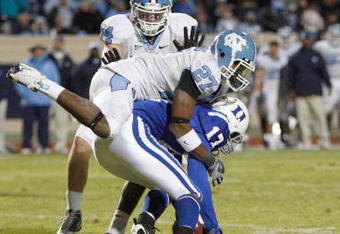 DURHAM, NC - NOVEMBER 29:  Sheldon Bell #17 of the Duke Blue Devils is tackled by Deunta Williams #27 and Chase Rice #44 of the North Carolina Tar Heels at Wallace Wade Stadium on November 29, 2008 in Durham, North Carolina. (Photo by Kevin C. Cox/Getty Images)