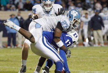 DURHAM, NC - NOVEMBER 29:  Sheldon Bell #17 of the Duke Blue Devils is tackled by Deunta Williams #27 and Chase Rice #44 of the North Carolina Tar Heels at Wallace Wade Stadium on November 29, 2008 in Durham, North Carolina. (Photo by Kevin C. Cox/Getty Images)