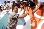 MIAMI - JANUARY 04: Head coach John Harbaugh of the Baltimore Ravens celebrates a 27-9 AFC Wild Card victory over the Miami Dolphins with fans on January 4, 2009 at Dolphin Stadium in Miami, Florida. (Photo by Gregory Shamus/Getty Images)