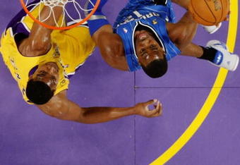 LOS ANGELES, CA - JUNE 4:  Dwight Howard #12 of the Orlando Magic shoots over the defense of Andrew Bynum #17 of the Los Angeles Lakers in Game One of the 2009 NBA Finals at Staples Center on June 4, 2009 in Los Angeles, California. NOTE TO USER: User expressly acknowledges and agrees that, by downloading and or using this photograph, User is consenting to the terms and conditions of the Getty Images License Agreement. (Photo by Jeff Gross/Getty Images)