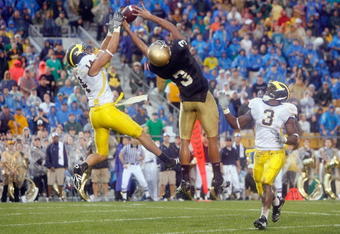 SOUTH BEND,IN - SEPTEMBER 13:  Morgan Trent #14 of the Michigan Wolverines reaches for the ball against Michael Floyd #3 of the Notre Dame Fighting Irish on September 13, 2008 at Notre Dame Stadium in South Bend, Indiana. (Photo by: Gregory Shamus/Getty Images)