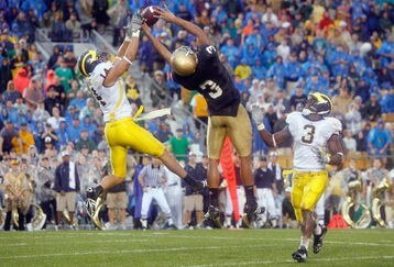 SOUTH BEND,IN - SEPTEMBER 13:  Morgan Trent #14 of the Michigan Wolverines reaches for the ball against Michael Floyd #3 of the Notre Dame Fighting Irish on September 13, 2008 at Notre Dame Stadium in South Bend, Indiana. (Photo by: Gregory Shamus/Getty Images)