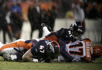 DENVER - DECEMBER 24:  John Lynch #47 of the Denver Broncos falls on the ball after a misqueued snap on an extra point attempt as Karl Paymah #41 covers kicker Shayne Graham #17 of the Cincinnati Bengals for the game winning play as the Broncos defeated the Bengals 24-23 on December 24, 2006 at Invesco Field at Mile High in Denver, Colorado.  (Photo by Doug Pensinger/Getty Images)
