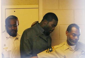 Sussex, VA - NOVEMBER 25:  Suspended Atlanta Falcons quarterback Michael Vick (C) leaves Surry County Circuit Court after entering a guilty plea on two felony counts connected to dog fighting on November 25, 2008 in Sussex, Virginia. Under a plea agreement, Vick, who is currently serving a term in prison for federal dog fighting charges, will serve one-year of probation for the state charges. He is scheduled to be released on July of 2009.  (Photo by Geoff Burke/Getty Images)