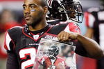 ATLANTA - DECEMBER 10:  DeAngelo Hall #21 of the Atlanta Falcons holds up a poster of Michael Vick during player intros against the New Orleans Saints on December 10, 2007 at the Georgia Dome in Atlanta, Georgia.  (Photo by Chris Graythen/Getty Images)