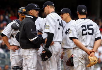 NEW YORK - MAY 17:  Manager Joe Girardi of the New York Yankees talks with A.J. Burnett #34 against the Minnesota Twins on May 17, 2009 at Yankee Stadium in the Bronx borough of New York City. The Yankees defeated the Twins 3-2 in ten innings.  (Photo by Jim McIsaac/Getty Images)