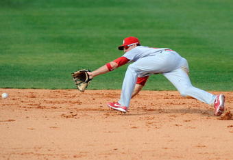 FORT LAUDERDALE, FL - FEBRUARY 26: Tyler Greene #67 of the St Louis Cardinals attempts to field a ground ball against the Baltimore Orioles during a spring training game at Fort Lauderdale Stadium on February 26, 2009 in Fort Lauderdale, Florida. (Photo by Rob Tringali/Getty Images)