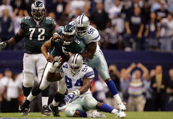 DALLAS - SEPTEMBER 15:  Quarterback Donovan McNabb #5 of the Philadelphia Eagles is sacked by Greg Ellis #98 and DeMarcus Ware #94 of the Dallas Cowboys in the fourth quarter at Texas Stadium on September 15, 2008 in Irving, Texas.  (Photo by Ronald Martinez/Getty Images)