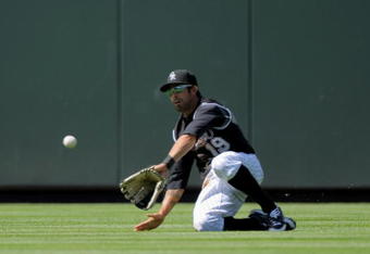 DENVER - MAY 14:  Center fielder Ryan Spilborghs #19 of the Colorado Rockies catches a fly ball against the Houston Astros during MLB action at Coors Field on May 14, 2009 in Denver, Colorado. The Astros defeated the Rockies 5-3.  (Photo by Doug Pensinger/Getty Images)