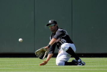 DENVER - MAY 14:  Center fielder Ryan Spilborghs #19 of the Colorado Rockies catches a fly ball against the Houston Astros during MLB action at Coors Field on May 14, 2009 in Denver, Colorado. The Astros defeated the Rockies 5-3.  (Photo by Doug Pensinger/Getty Images)