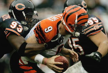 CHICAGO - SEPTEMBER 25:  Adewale Ogunleye #93 of the Chicago Bears sacks Carson Palmer #9 of the Cincinnati Bengals on September 25, 2005 at Soldier Field in Chicago, Illinois. The Bengals defeated the Bears 24-7. (Photo by Jonathan Daniel/Getty Images)