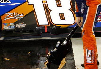 NASHVILLE, TN - JUNE 06:  Kyle Busch, driver of the #18 NOS Energy Drink Toyota celebrates by smashing the Gibson Guitar given to the winner after winning the NASCAR Nationwide Series Federated Auto Parts 300 at the Nashville Superspeedway on June 6, 2009 in Lebanon,Tennessee.  (Photo by Chris Graythen/Getty Images for NASCAR)