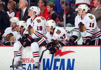 NEWARK, NJ - MARCH 17:  (L-R) Jonathan Toews #19, Adam Burish #37 and Andrew Ladd #16 of the Chicago Blackhawks look on from the bench against the New Jersey Devils at the Prudential Center on March 17, 2009 in Newark, New Jersey.  (Photo by Jim McIsaac/Getty Images)