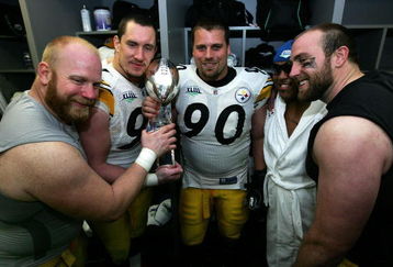 TAMPA, FL - FEBRUARY 01:  (L-R) Chris Hoke #76, Aaron Smith #91 Travis Kirschke #90,  Casey Hampton #98 and Brett Keisel #99 of the Pittsburgh Steelers celebrates with the Vince Lombardi trophy in the locker room after defeating the Arizona Cardinals during Super Bowl XLIII on February 1, 2009 at Raymond James Stadium in Tampa, Florida. The Steelers won the game by a score of 27-23.  (Photo by Al Bello/Getty Images)