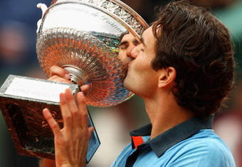 PARIS - JUNE 07:  Roger Federer of Switzerland kisses the trophy as he celebrates victory during the Men's Singles Final match against Robin Soderling of Sweden on day fifteen of the French Open at Roland Garros on June 7, 2009 in Paris, France.  (Photo by Clive Brunskill/Getty Images)