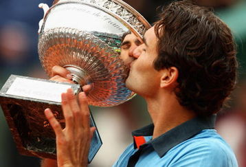 PARIS - JUNE 07:  Roger Federer of Switzerland kisses the trophy as he celebrates victory during the Men's Singles Final match against Robin Soderling of Sweden on day fifteen of the French Open at Roland Garros on June 7, 2009 in Paris, France.  (Photo by Clive Brunskill/Getty Images)