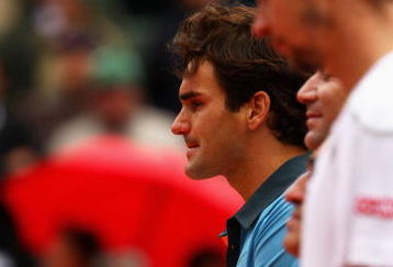 PARIS - JUNE 07:  A tear rolls down the cheek of an emotional Roger Federer of Switzerland as he poses with the trophy during the Men's Singles Final match against Robin Soderling of Sweden on day fifteen of the French Open at Roland Garros on June 7, 2009 in Paris, France.  (Photo by Clive Brunskill/Getty Images)