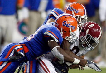 ATLANTA - DECEMBER 06:  Julio Jones #8 of the Alabama Crimson Tide tackled by Joe Haden #5 and Major Wright #21 of the Florida Gators during the SEC Championship on December 6, 2008 at the Georgia Dome in Atlanta, Georgia. The Gators defeated the Crimson Tide 31-20.  (Photo by Chris Graythen/Getty Images)