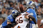 DETROIT - OCTOBER 05:  Alex Brown #96 of the Chicago Bears causes a fumble on a sack of Jon Kitna #8 of the Detroit Lions while defended by Jeff Backus #76 during the first quarter at Ford Field on October 5, 2008 in Detroit, Michigan.  The Bears won 34-7.   (Photo by Harry How/Getty Images)