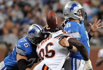 DETROIT - OCTOBER 05:  Alex Brown #96 of the Chicago Bears causes a fumble on a sack of Jon Kitna #8 of the Detroit Lions while defended by Jeff Backus #76 during the first quarter at Ford Field on October 5, 2008 in Detroit, Michigan.  The Bears won 34-7.   (Photo by Harry How/Getty Images)