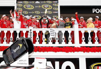 LONG POND, PA - JUNE 07:  Tony Stewart, driver of the #14 Office Depot/Old Spice Chevrolet, celebrates in victory lane after winning the NASCAR Sprint Cup Series Pocono 500 on June 7, 2009 at Pocono Raceway in Long Pond, Pennsylvania.  (Photo by Geoff Burke/Getty Images for NASCAR)
