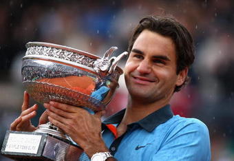 PARIS - JUNE 07:  Roger Federer of Switzerland poses with the trophy as he celebrates victory during the Men's Singles Final match against Robin Soderling of Sweden on day fifteen of the French Open at Roland Garros on June 7, 2009 in Paris, France.  (Photo by Ryan Pierse/Getty Images)