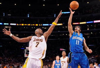 LOS ANGELES, CA - JUNE 07:  Courtney Lee #11 of the Orlando Magic shoots over Lamar Odom #7 of the Los Angeles Lakers in Game Two of the 2009 NBA Finals at Staples Center on June 7, 2009 in Los Angeles, California. NOTE TO USER: User expressly acknowledges and agrees that, by downloading and or using this photograph, User is consenting to the terms and conditions of the Getty Images License Agreement.  (Photo by Mark J. Terrill-Pool/Getty Images)