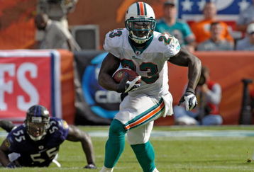 MIAMI, FL - JANUARY 4:  Running back Ronnie Brown #23 of the Miami Dolphins rushes upfield against the Baltimore Ravens during their AFC Wild Card Game at Dolphins Stadium on January 4, 2009 in Miami, Floirda.  (Photo by Al Messerschmidt/Getty Images)