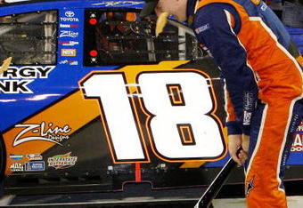 NASHVILLE, TN - JUNE 06:  Kyle Busch, driver of the #18 NOS Energy Drink Toyota celebrates by smashing the Gibson Guitar given to the winner after winning the NASCAR Nationwide Series Federated Auto Parts 300 at the Nashville Superspeedway on June 6, 2009 in Lebanon,Tennessee.  (Photo by Chris Graythen/Getty Images for NASCAR)
